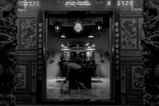 a man cleaning the floor of a Temple In Penang